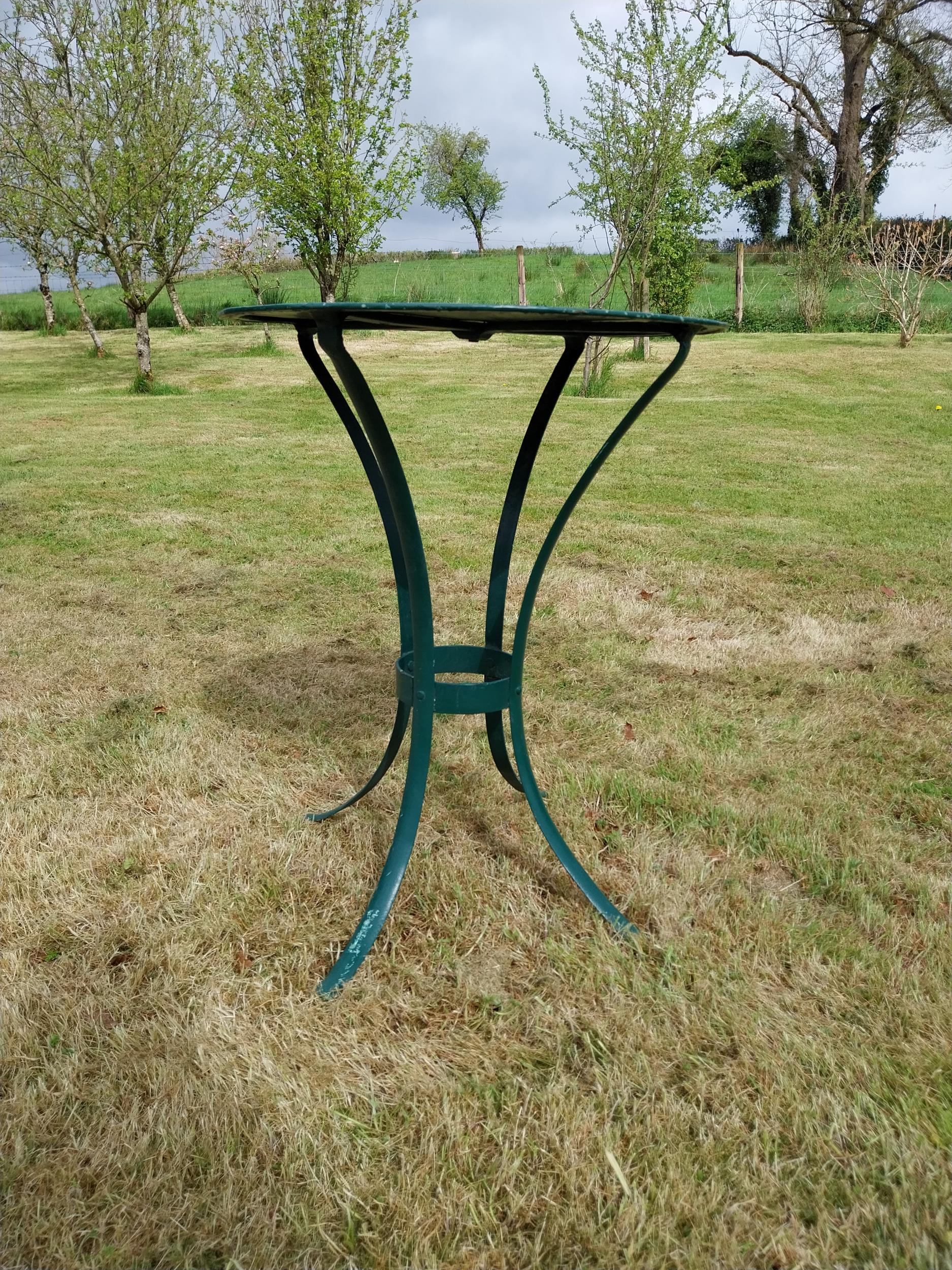 Painted metal circular garden table {}.