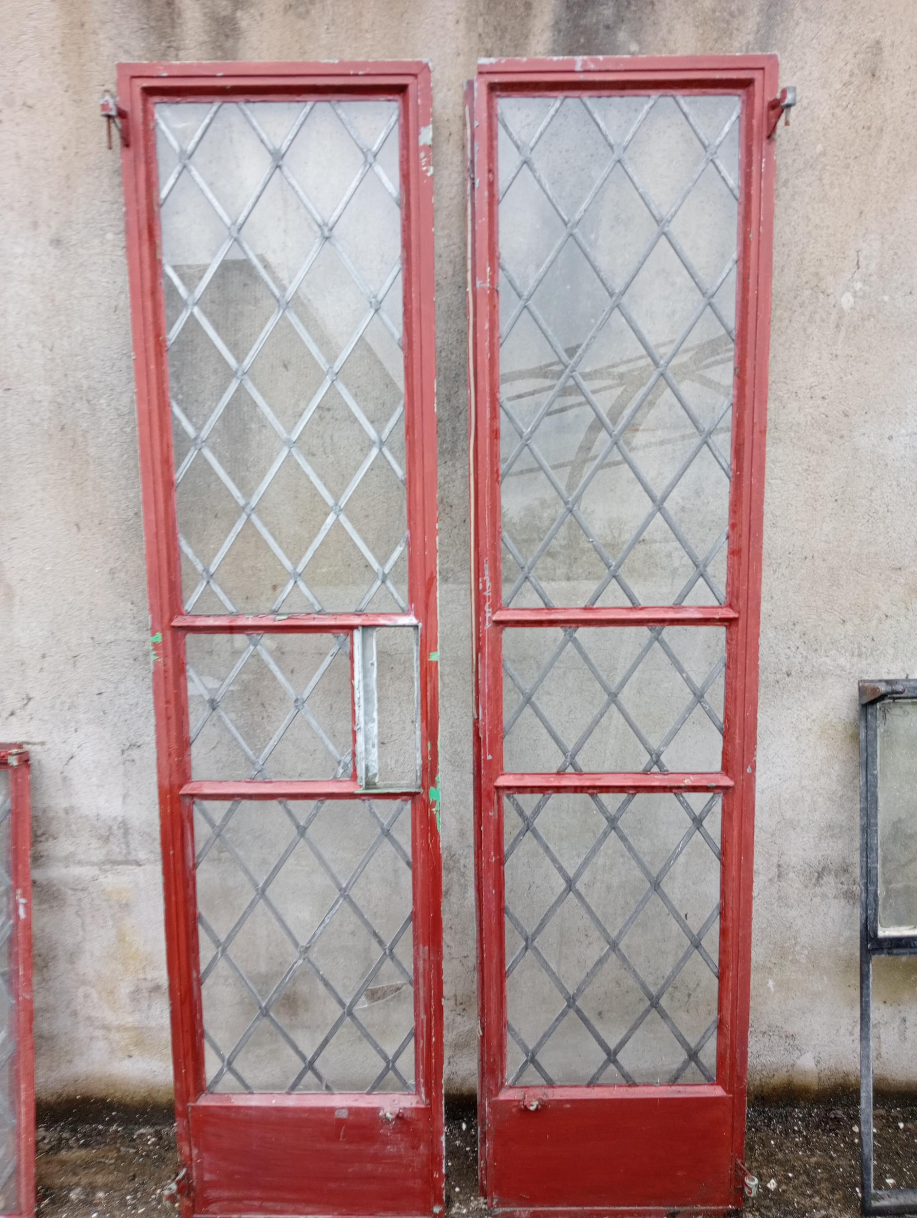 Pair of tall cast iron leaded windows {Each H 202cm x W 48cm }.