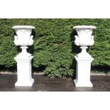 Pair of composition urns raised on pedestals {H183cm x W60cm x D60cm }. (NOT AVAILABLE TO VIEW IN