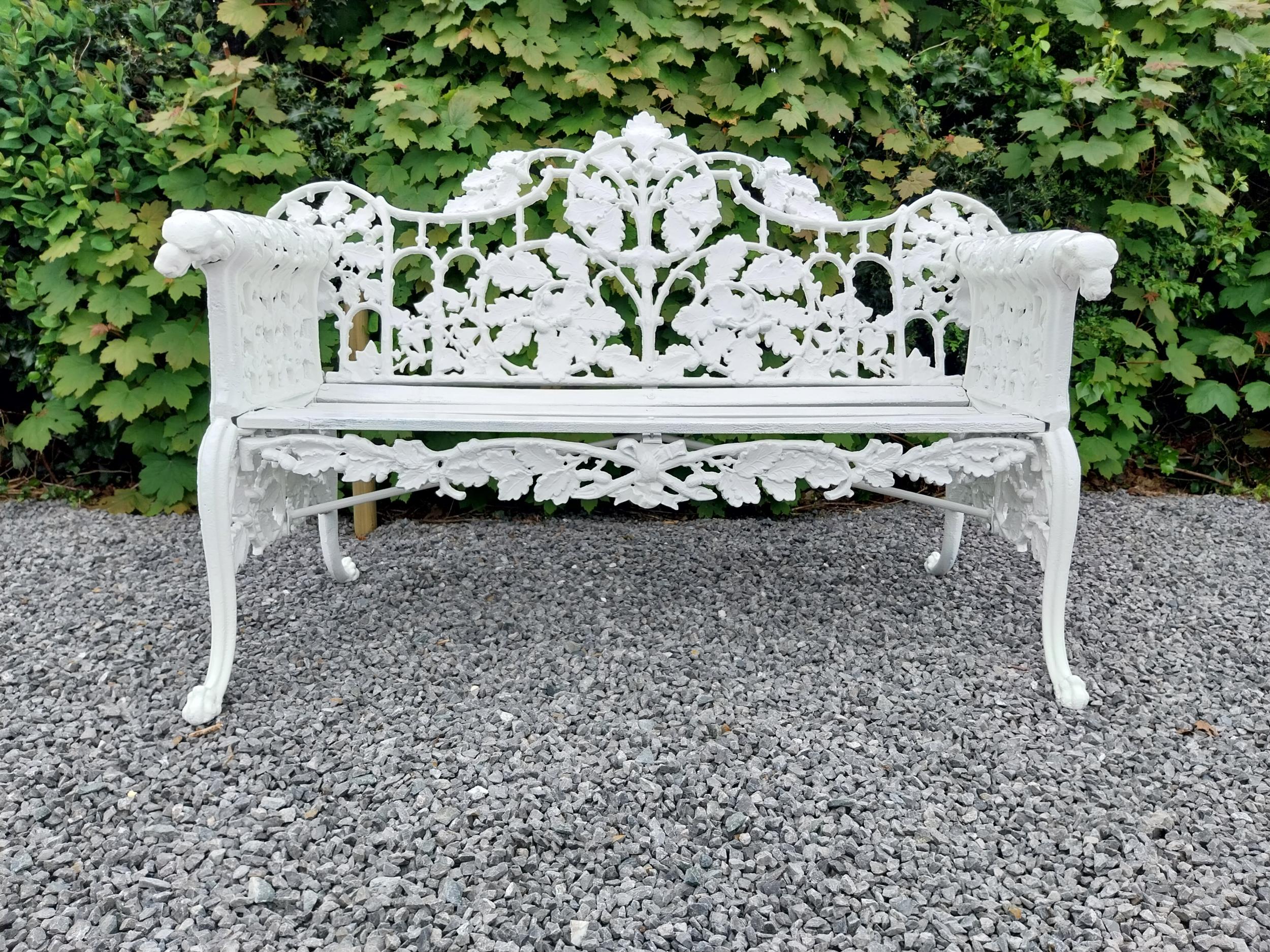Good quality cast iron garden bench decorated with oak leaf and dogs heads in the Coalbrookdale