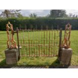 Wrought iron entrance gate with scroll design posts mounted on stone bases {H 113cm x W 178cm x D