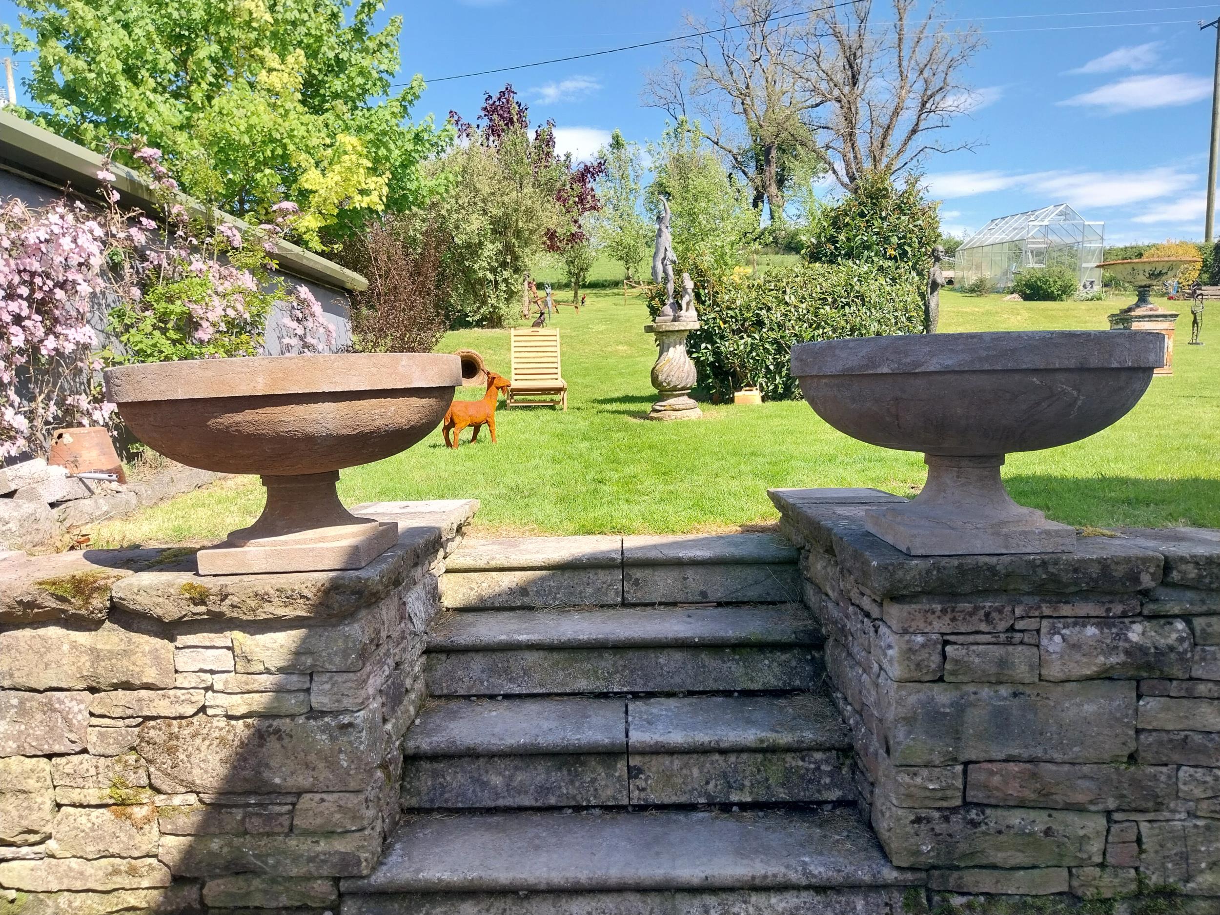 Pair of good quality hand carved limestone urns in the Georgian style {48 cm H x 80 cm Dia.}.