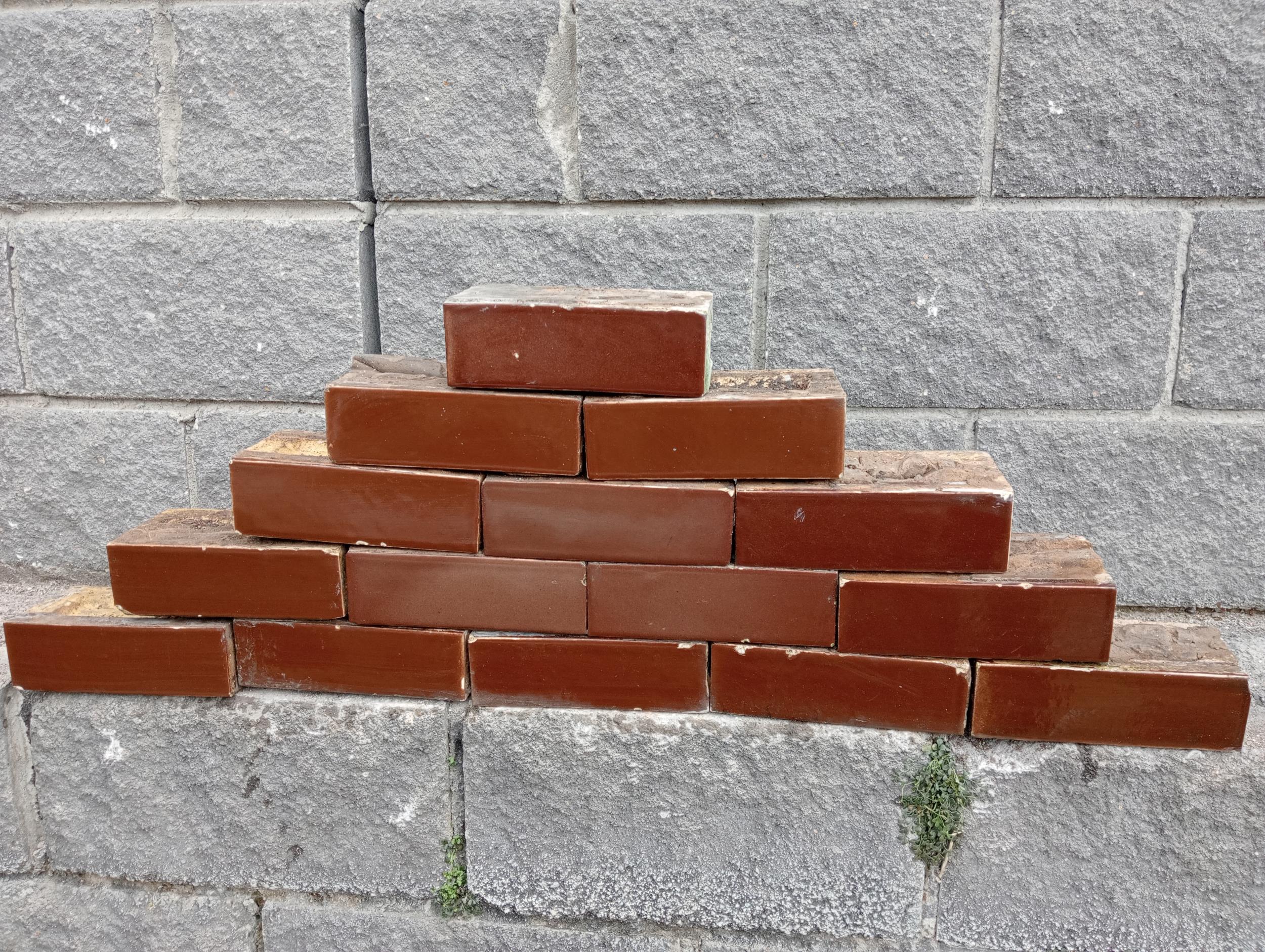 Collection of one hundred and ten red glazed bricks {H 8cm x W 23cm x D 11cm }.