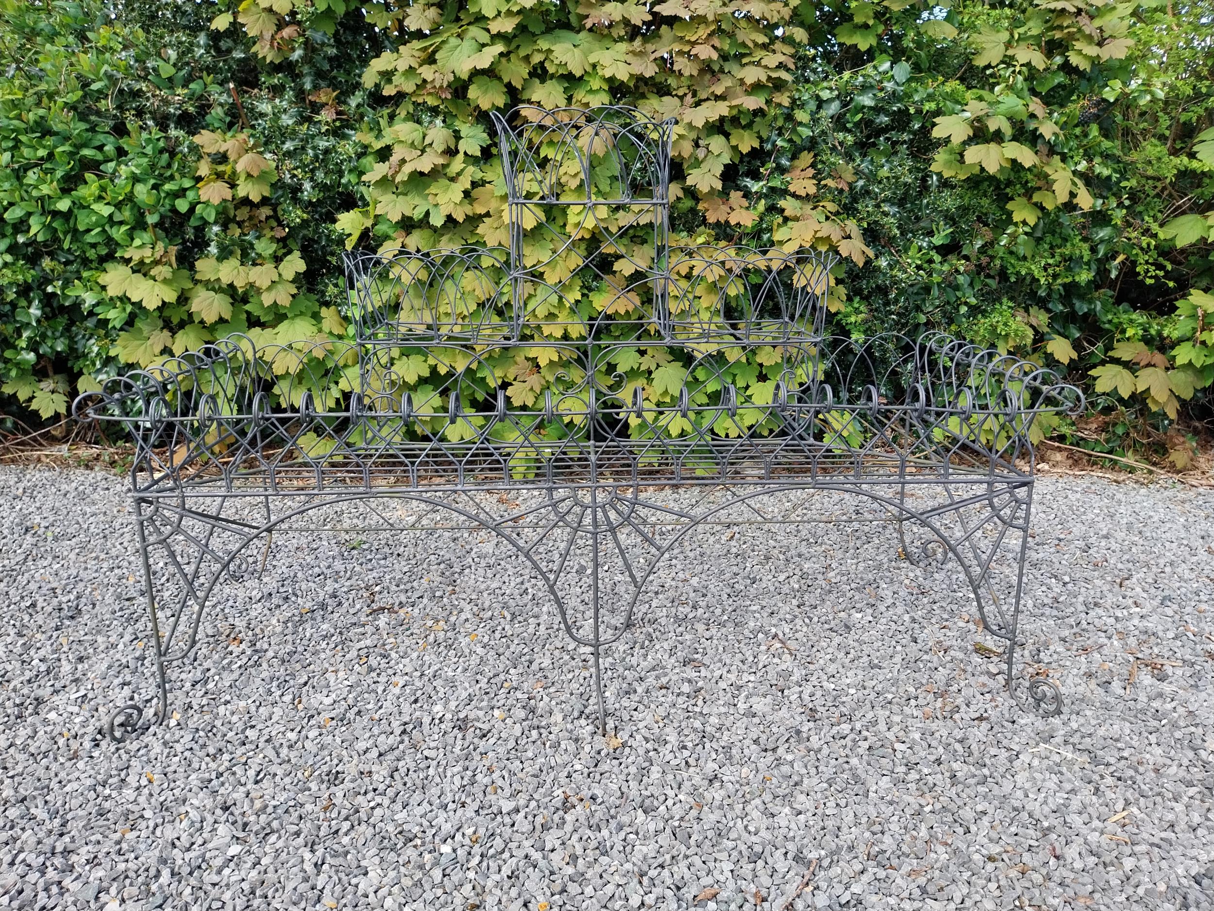 Wrought iron wired three-tiered waterfall plant stand {105 cm H x 168 cm W x 67 cm D}.