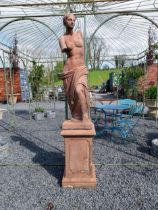 Moulded terracotta Venus de Milo statue raised on pedestal {200 cm H x 47 cm W x 47 cm D}.