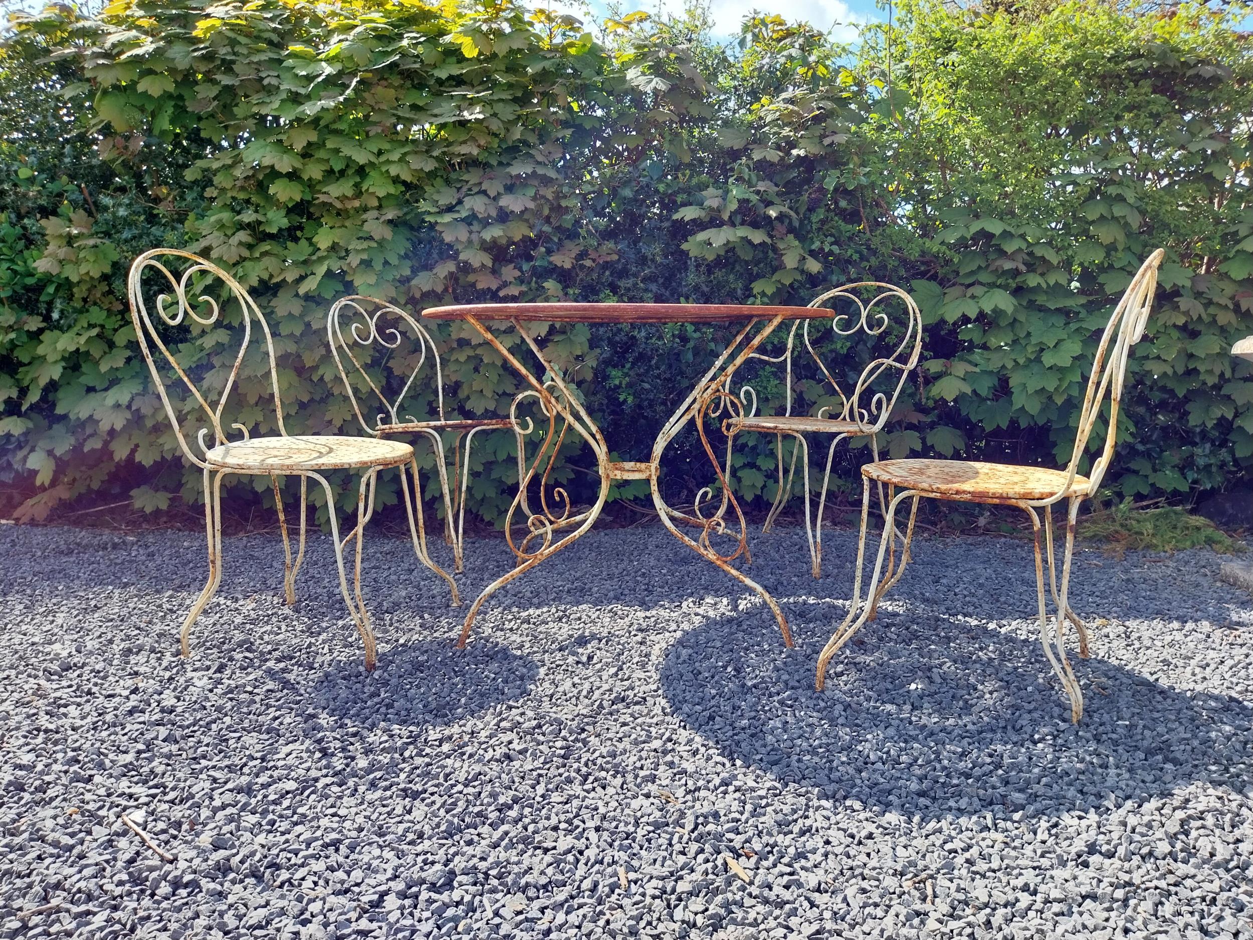 Early 20th C. French wrought iron garden table with three matching chairs and one matching