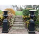 Pair of cast iron urns and bases {H. 185cm x Dia 66cm Base H 93cm x 53 x 53}. (NOT AVAILABLE TO VIEW