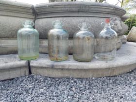 Collection of four glass demijohns {36 cm H x 16 cm Dia.}.