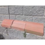Collection of thirty terracotta saddle back copings {H 13cm x W 30cm x D 18cm }. (NOT AVAILABLE TO