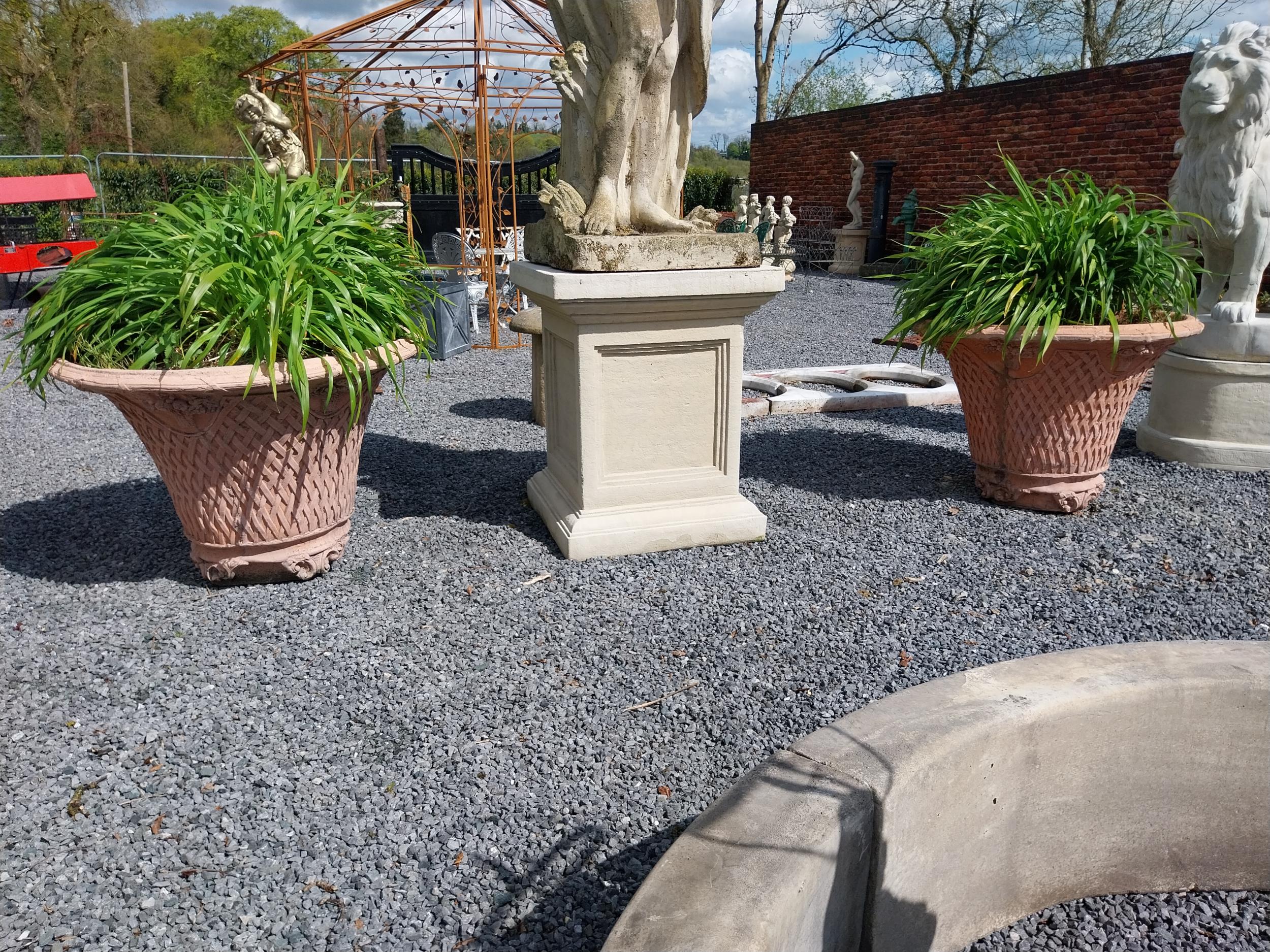 Pair of moulded terracotta lattice urns {79 cm H x 100 cm Dia.}.