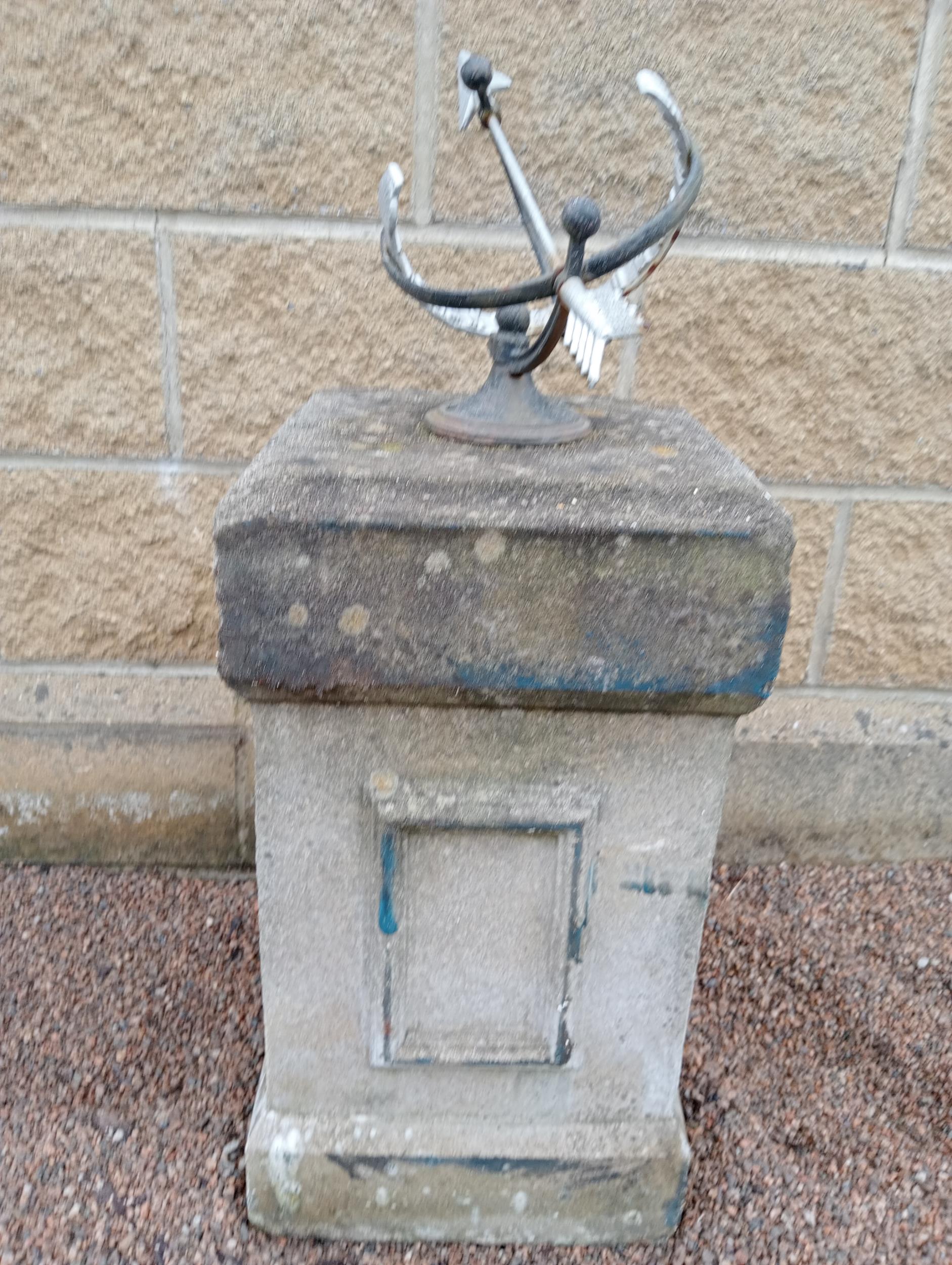 Wrought iron Armorial sundial raised on composition stone square pedestal {H 80cm x 33 x 33}. (NOT