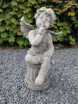 Moulded stone figure of a winged Cherub {58 cm H x 31 cm W x 23 cm D}.