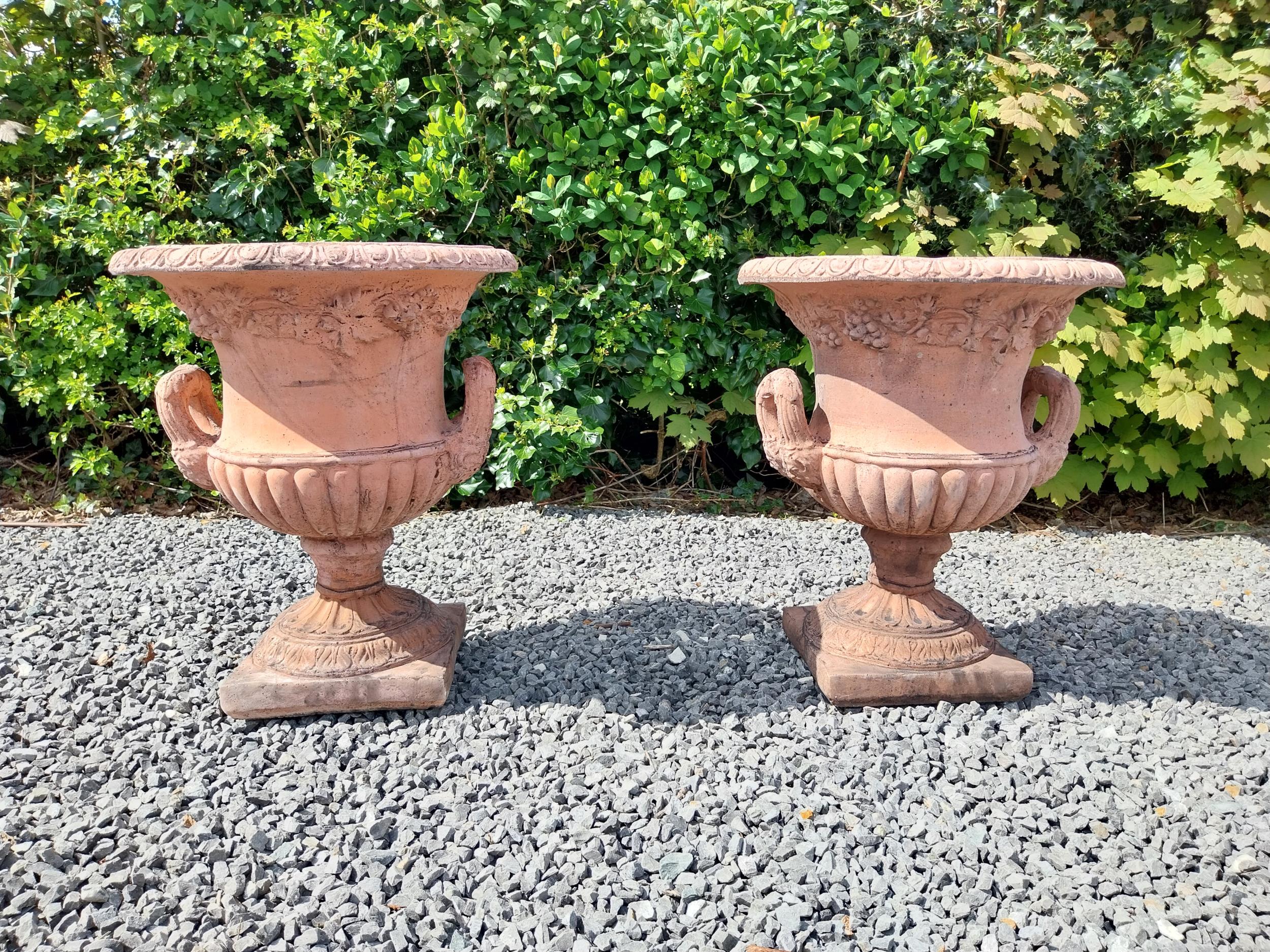 Pair of moulded terracotta lattice urns ivy leaf decoration {56 cm H x 46 cm Dia.}.