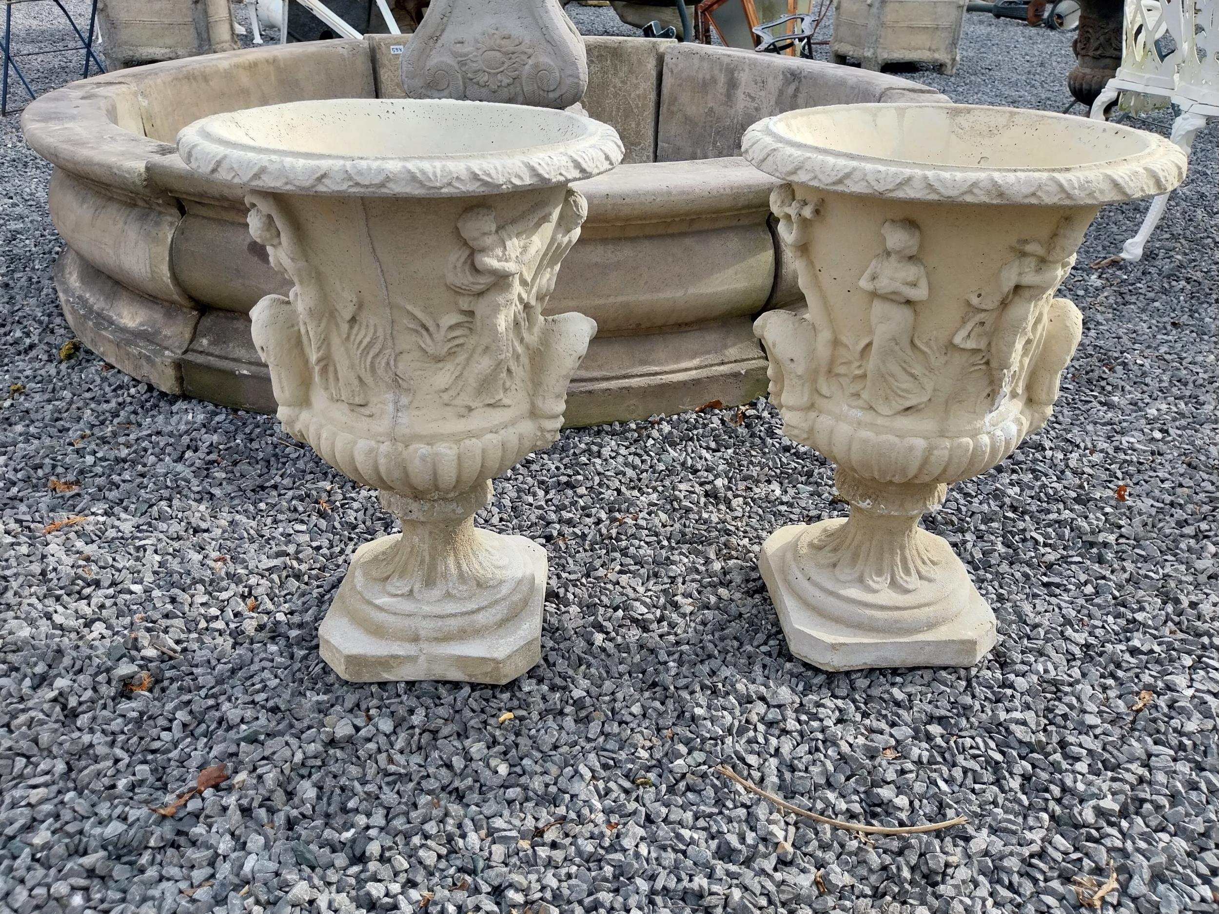 Pair of good quality moulded sandstone Grecian urns {57 cm H x 39 cm Dia.}.