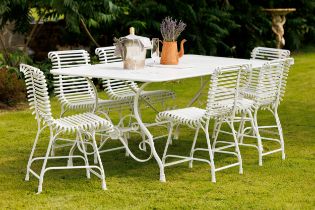 Exceptional quality hand forged wrought iron Arras style garden table and six matching ladder back