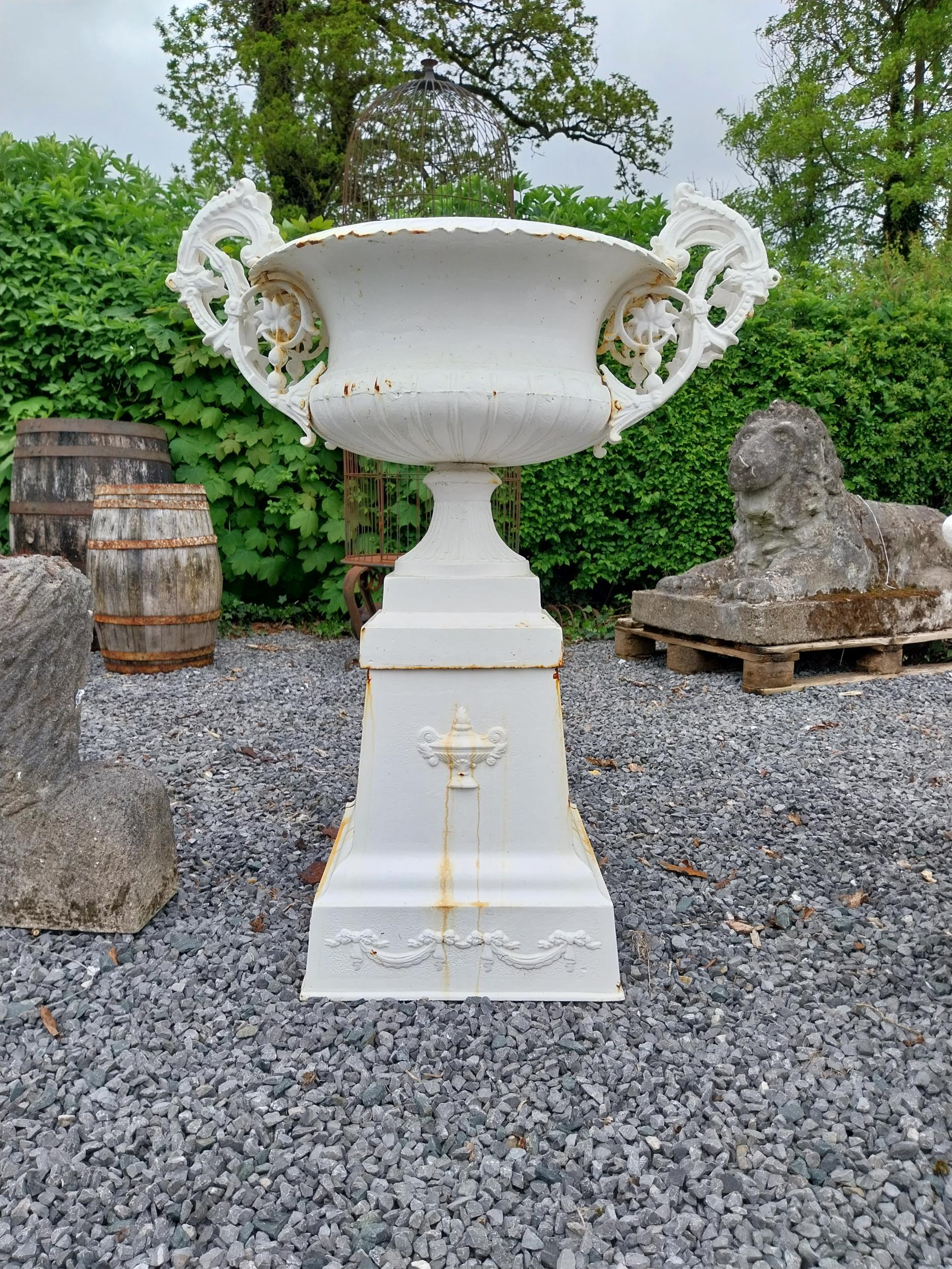Decorative French cast iron urn raised on pedestal {109 cm H x 86 cm W x 60 cm D}. (NOT AVAILABLE TO