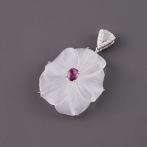 Carved Rock Crystal Pendant, centering a small oval cut ruby and suspended from a 14k white gold mou