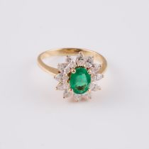 14k Yellow And White Gold Ring, set with an oval cut emerald (approx. 0.81ct.) and 12 marquise cut d