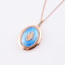 14k Yellow Gold Oval Locket, decorated with blue enamel and suspended on a 14k yellow gold curb link