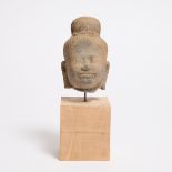 A Khmer Stone Head of Buddha, 12th Century, including stand height 8.4 in — 21.3 cm