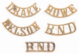 5 WWI Royal Naval Division brass shoulder titles: "NELSON", "DRAKE", "HOWE", straight "RND" and