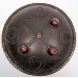 An Indian circular iron shield, dhal, 12" diameter, with 4 applied iron heart shaped panels, brass