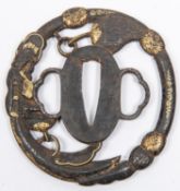A pierced iron tsuba, signed, and with gold decoration. GC, some wear to the gold. £50-100