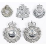 Four obsolete Devon Constabulary badges: chrome plated ERII wreath pattern helmet badge; another