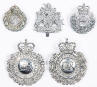 Four obsolete Devon Constabulary badges: chrome plated ERII wreath pattern helmet badge; another