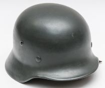 A Third Reich M35 steel helmet, repainted at an early date with grey paint, complete with lining and