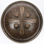 An Indian Benares brass shield, 12½" diameter, intricately decorated overall with leaves, tendrils