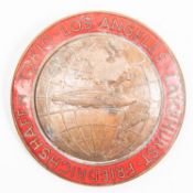 A circular bronze and enamel pin back badge to mark the flight of the Graf Zeppelin to Tokyo,