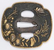 A bronzed tsuba, of quatrefoil shape, with gold rim, embossed and overlaid with gold and silver