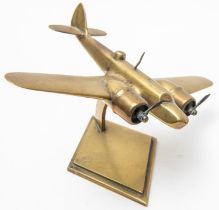 A WWII brass model of a Bristol Blenheim twin engined aircraft, wing span 9", mounted on a brass