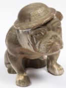 A painted bisque figure of a seated bulldog wearing a steel helmet inscribed "Hitler's Terror",
