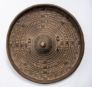 A Somali thick hide shield, 13" diameter, with turned out rim, raised central boss, concentric rings