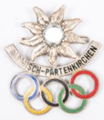 A Third Reich pin back badge for the 1936 Winter Olympics, in white metal and enamel, inscribed "