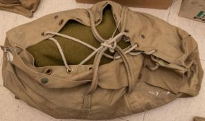 A WWII cape ground sheet; a ground sheet; a pair of braces, webbing belt, leather gaiters; a US Army