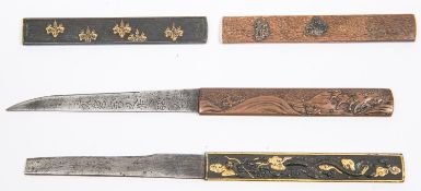 A kozuka, of shakudo finely embossed and gold overlaid with a dragon and clouds, with gold back