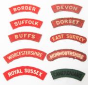 10 WWII British army printed infantry shoulder titles: Border, Suffolk, Devon, Dorset, Buffs, East