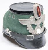 A German Police shako, with Third Reich aluminium eagle badge and cockade. GC £300-350