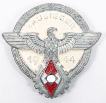 A Third Reich Hitler Youth Gausieger pin back badge, dated 1944, of painted grey metal, the back