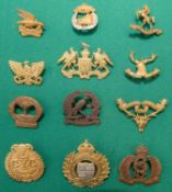 A set of New Zealand Mounted Rifles cap badges, from 1st to 12th, the majority New Zealand made with
