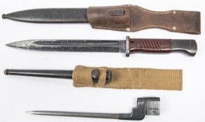 A Third Reich K98 bayonet, with unmarked blade and brown bakelite grips, in its scabbard with