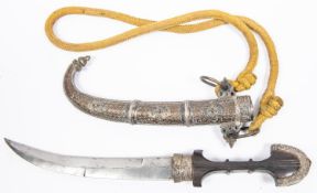An old Moroccan jambiya, blade 9½", the hilt of wood with engraved silver pommel and ferrule, in its