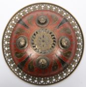 A decorative Indian Benares brass shield, dhal, 11" diameter, with pierced rim and centre, with
