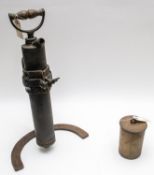 A WWI Trench pump, complete with iron frame, also an 18pdr shell case adapted as a gas warning.