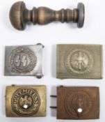 Three reproduction Third Reich belt buckles; another German buckle; and a document stamp with turned