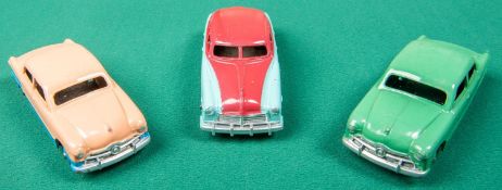 3 Dinky Toys American cars. A Ford Sedan, a low-line example in pink and blue with blue wheels.