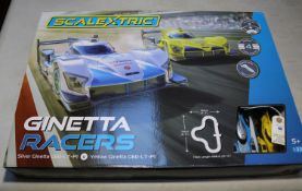Scalextric Ginetta Racers 1:32 scale. Contains a silver Ginetta G60-LT-P1, and a yellow Ginetta